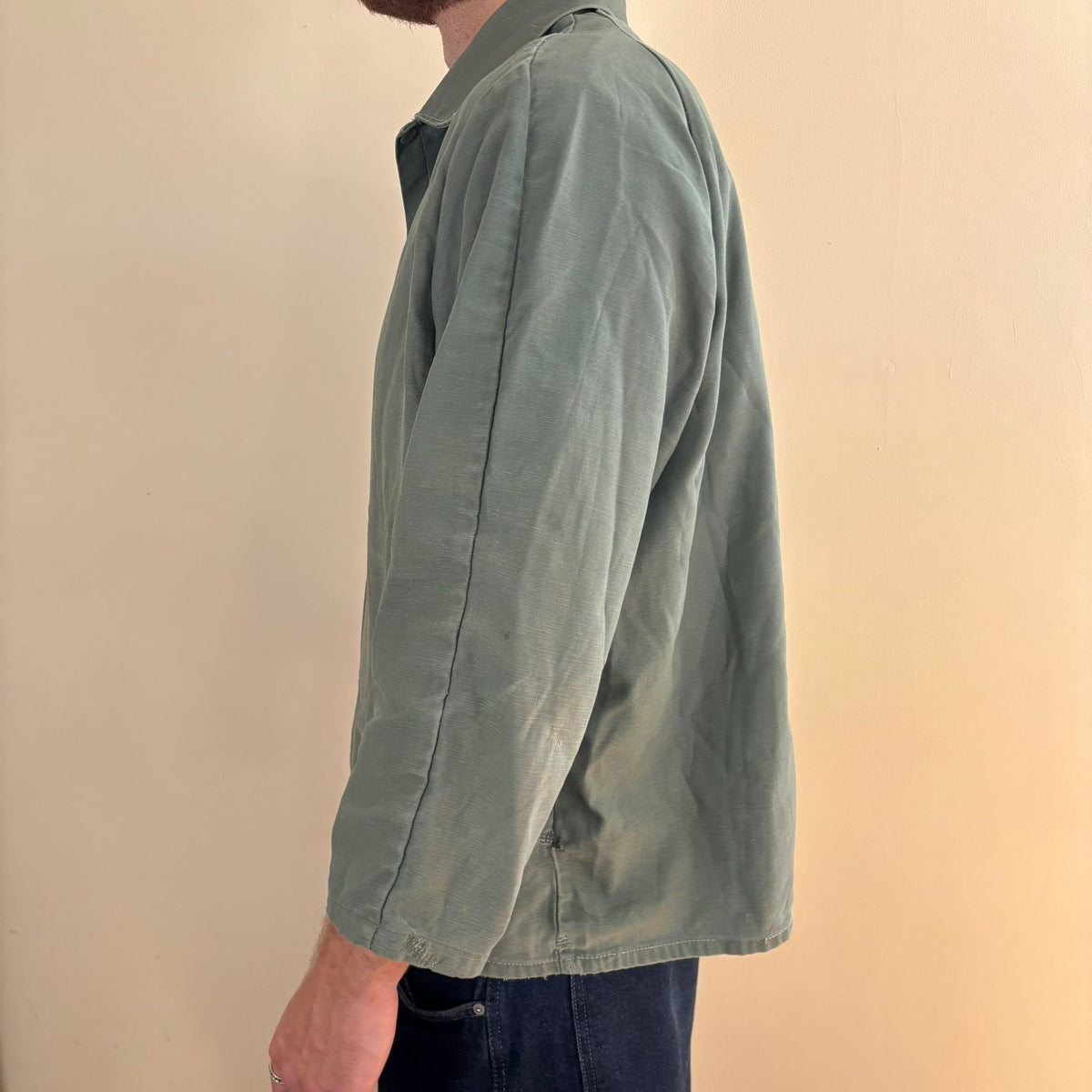 Vintage green cotton work jacket with snap front and stencilled "McLOUTH" on back.