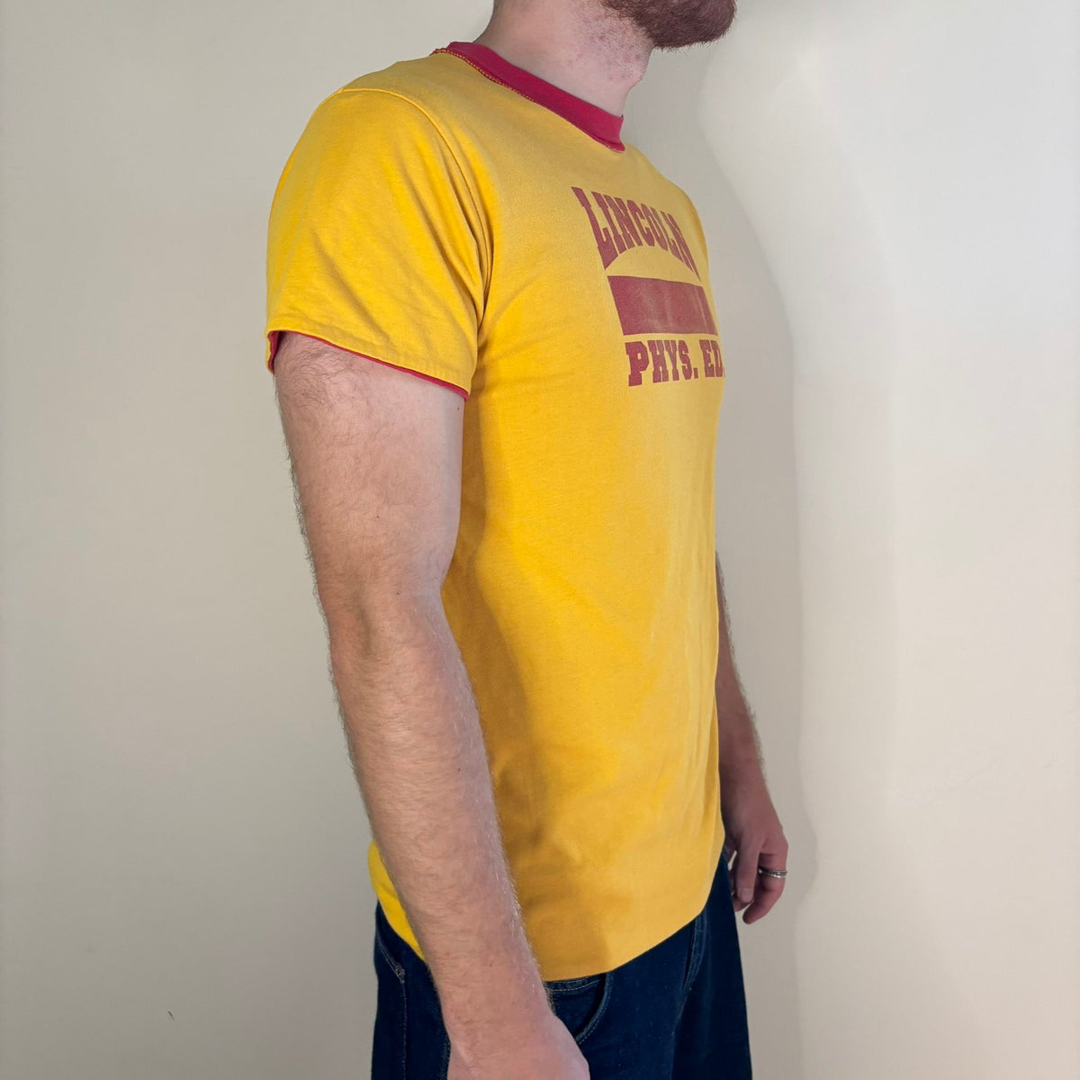 Vintage 70s Lincoln Phys Ed reversible shirt red yellow crew neck with contrasting print.