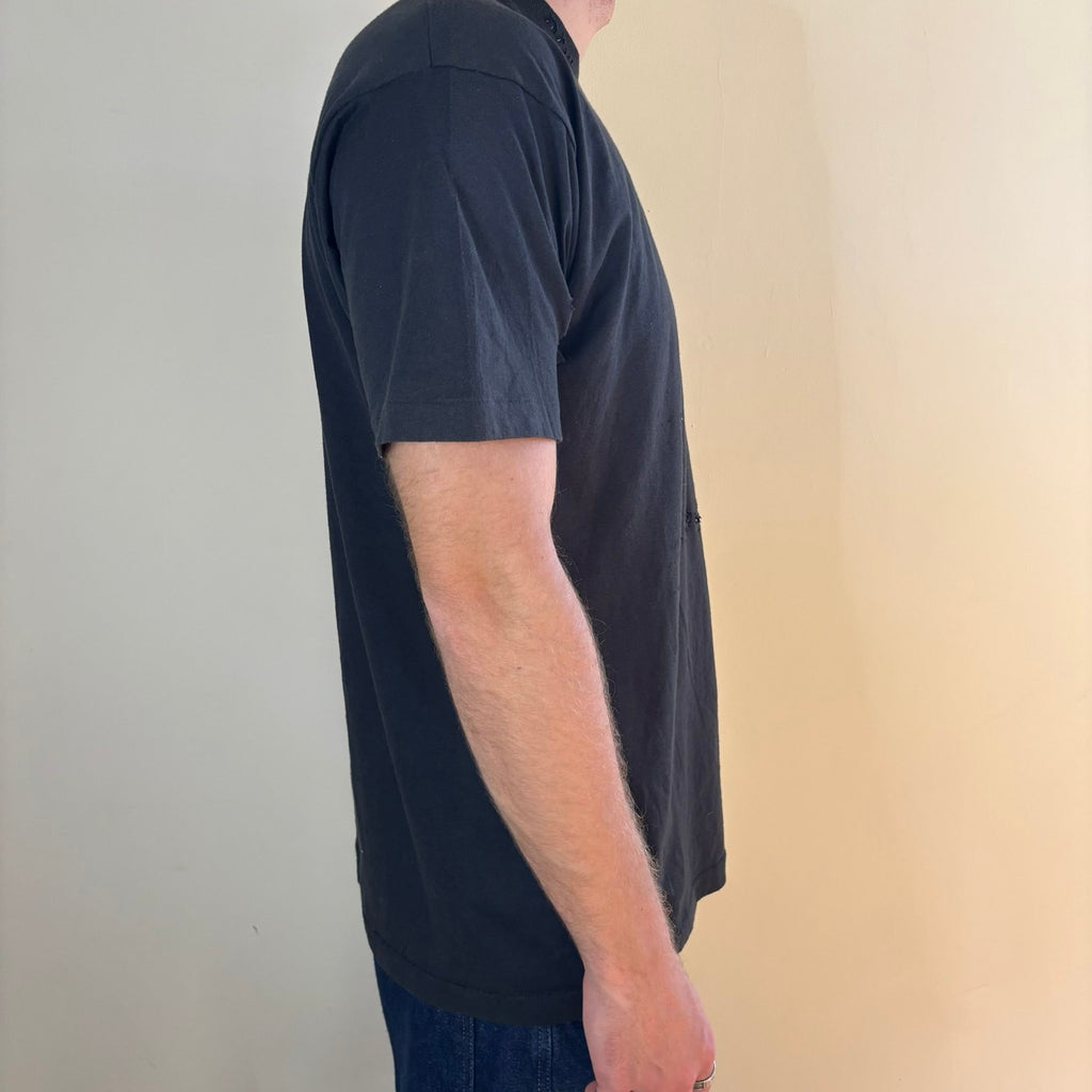 Vintage black band t-shirt single-stitch with ghost pocket detail and faded charcoal color.
