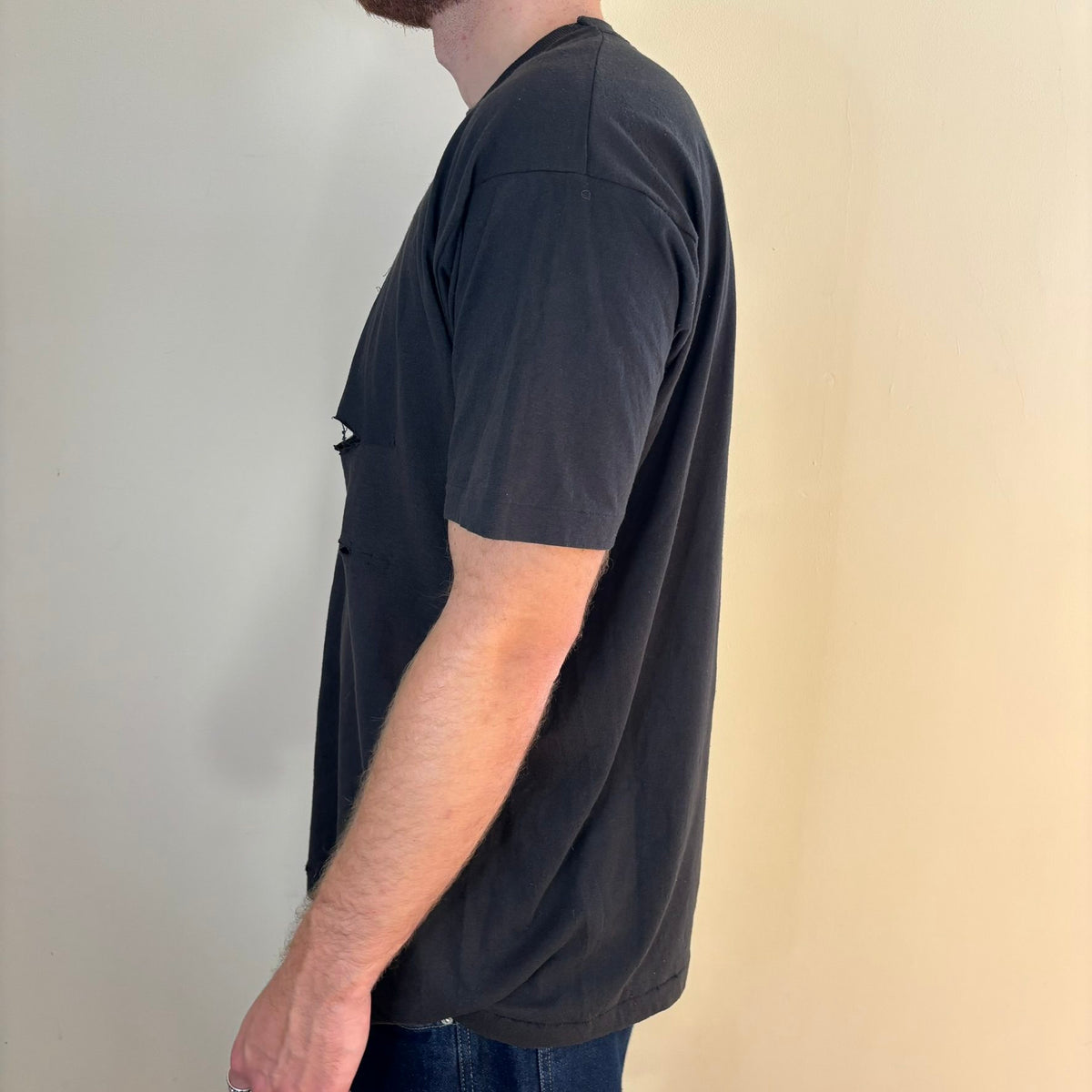 Vintage black band t-shirt single-stitch with ghost pocket detail and faded charcoal color.