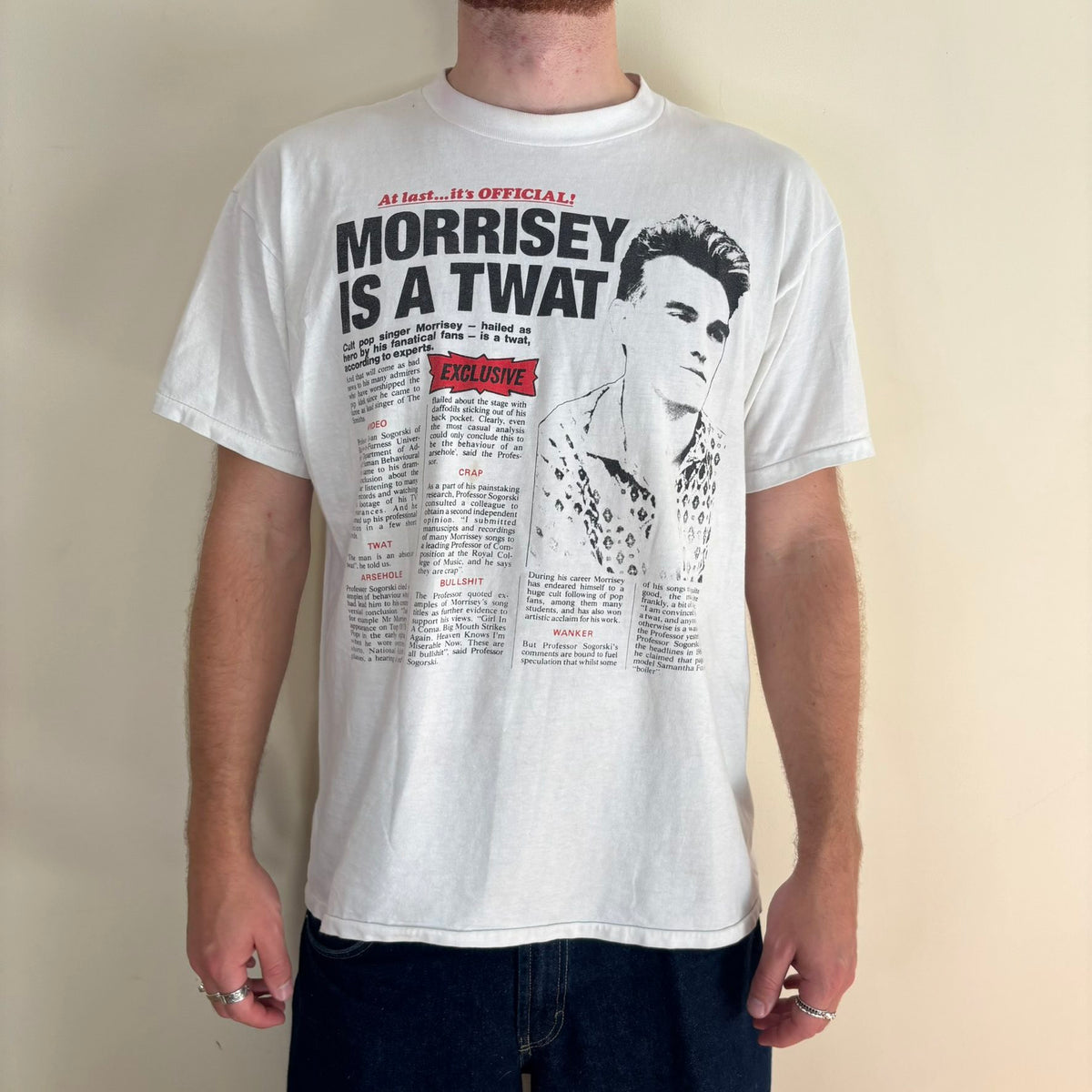 Oneita black graphic tee featuring Morrissey tabloid print and red "EXCLUSIVE" flash.