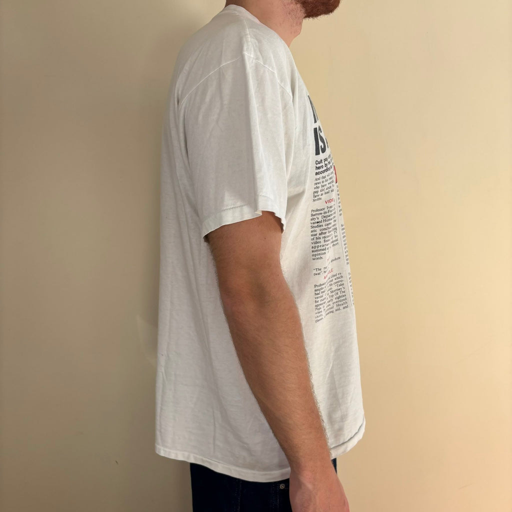 Oneita black graphic tee featuring Morrissey tabloid print and red "EXCLUSIVE" flash.