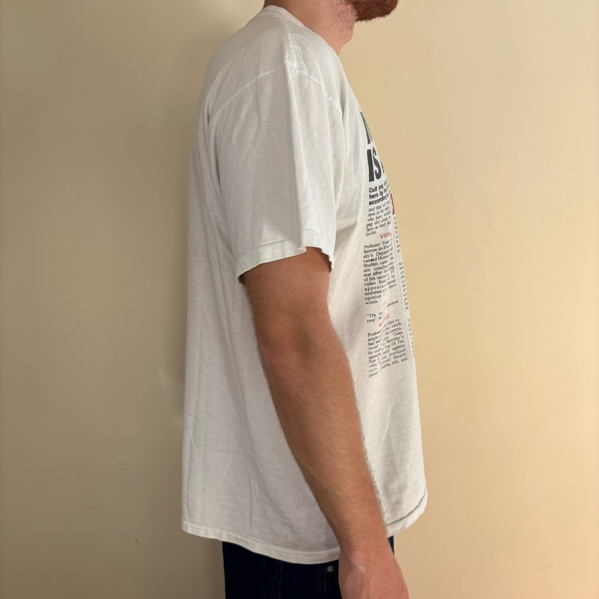 Oneita black graphic tee featuring Morrissey tabloid print and red "EXCLUSIVE" flash.