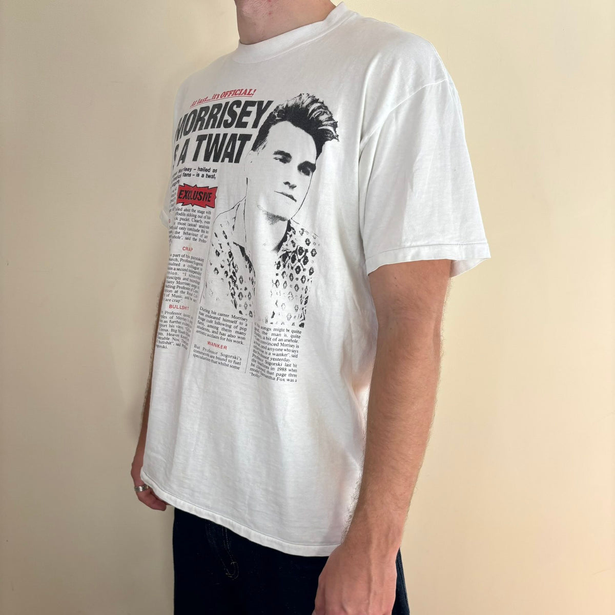 Oneita black graphic tee featuring Morrissey tabloid print and red "EXCLUSIVE" flash.