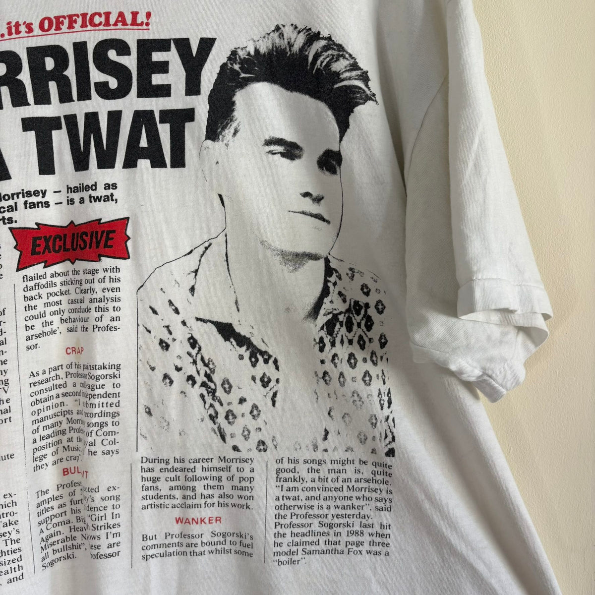 Oneita black graphic tee featuring Morrissey tabloid print and red "EXCLUSIVE" flash.