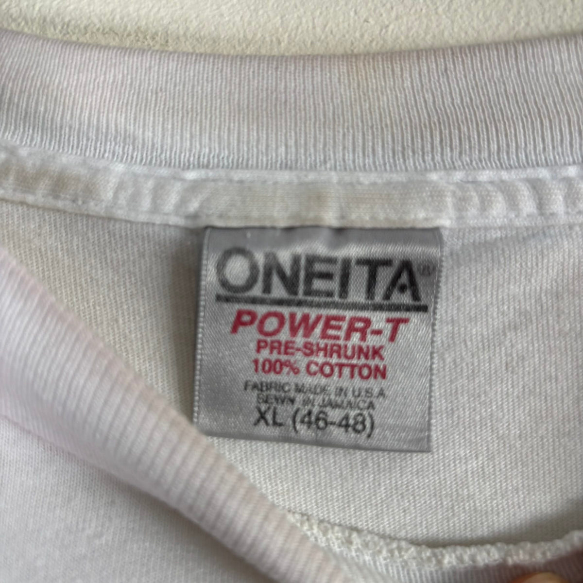 Oneita black graphic tee featuring Morrissey tabloid print and red "EXCLUSIVE" flash.