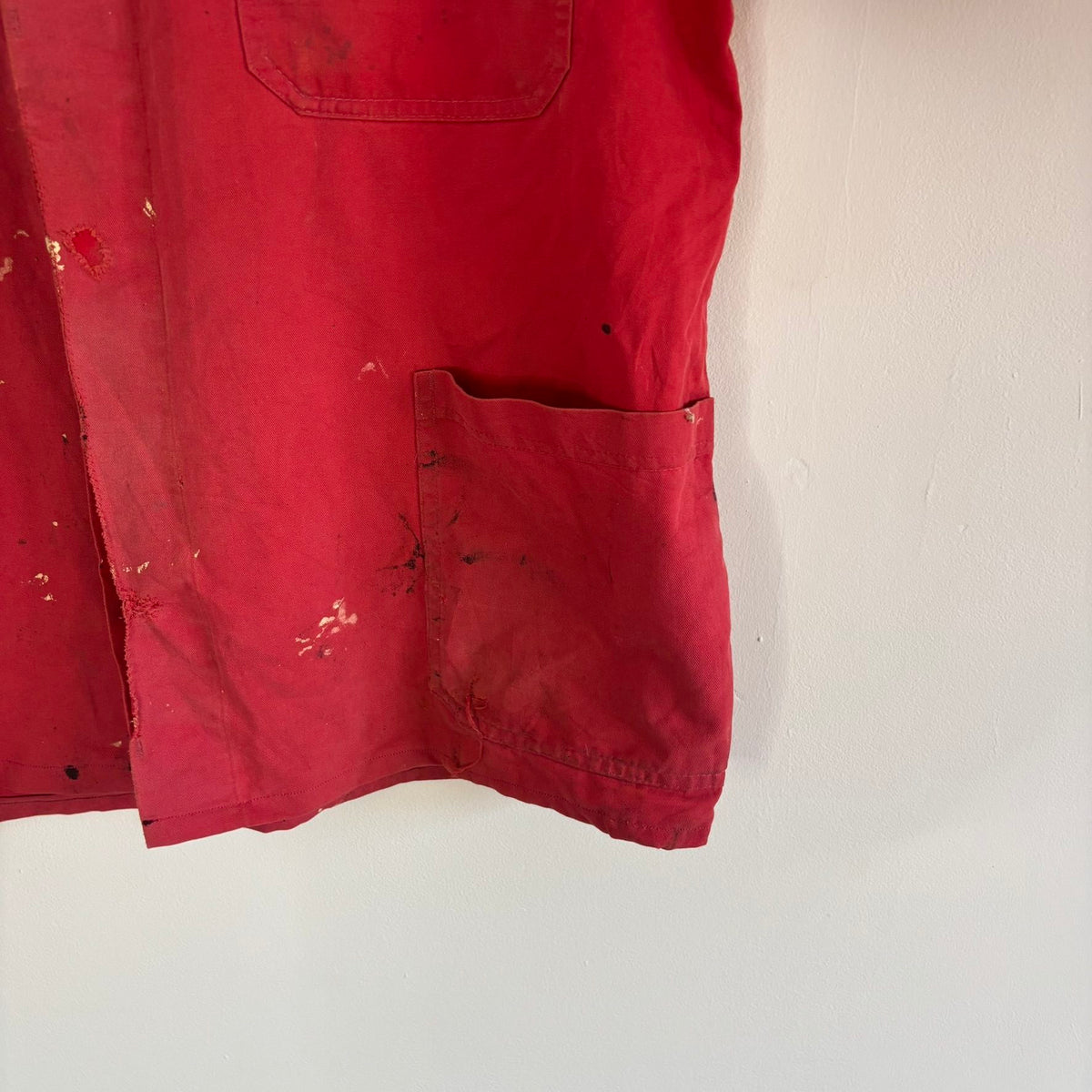 Vintage Euro workwear red chore jacket with faded paint splatters and three-pocket design.
