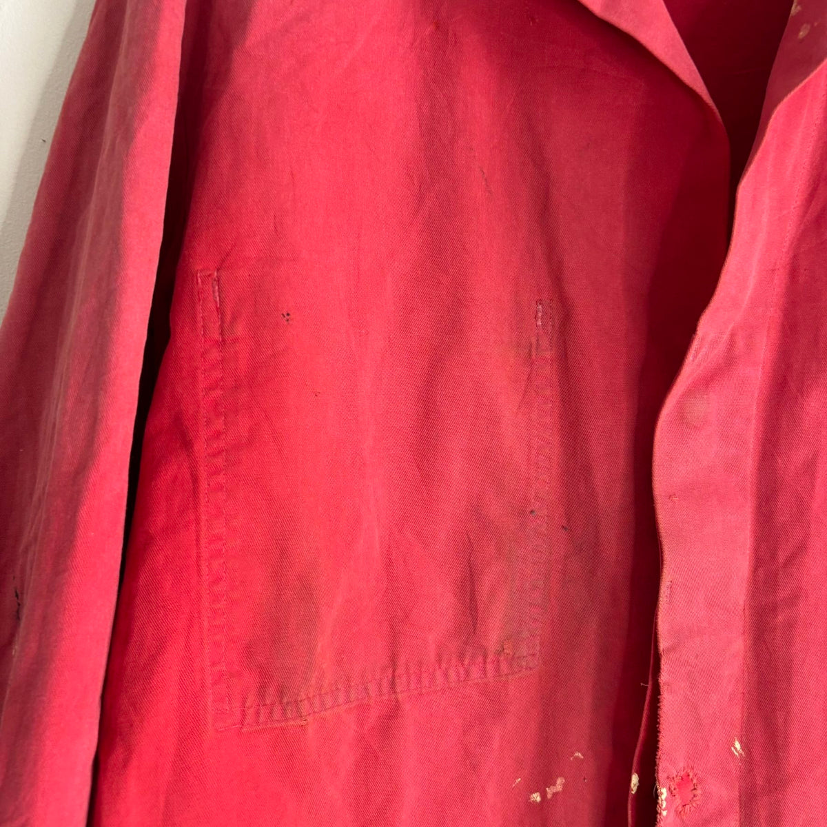 Vintage Euro workwear red chore jacket with faded paint splatters and three-pocket design.