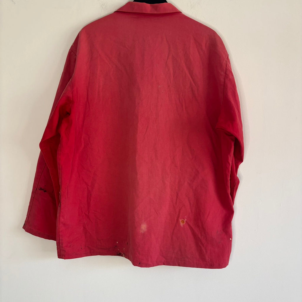 Vintage Euro workwear red chore jacket with faded paint splatters and three-pocket design.