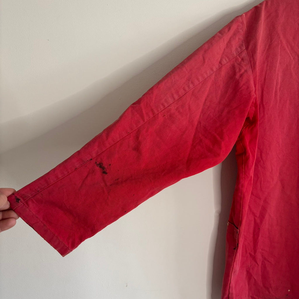 Vintage Euro workwear red chore jacket with faded paint splatters and three-pocket design.
