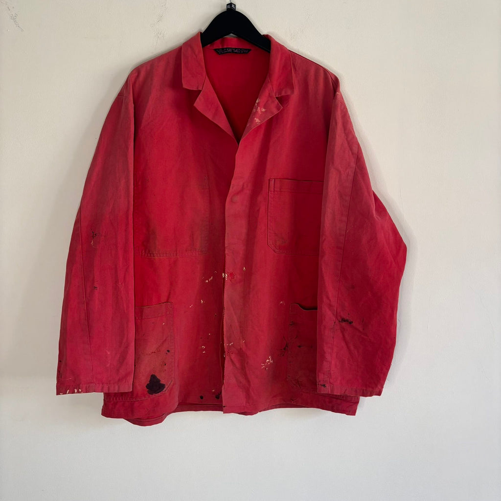 Vintage Euro workwear red chore jacket with faded paint splatters and three-pocket design.