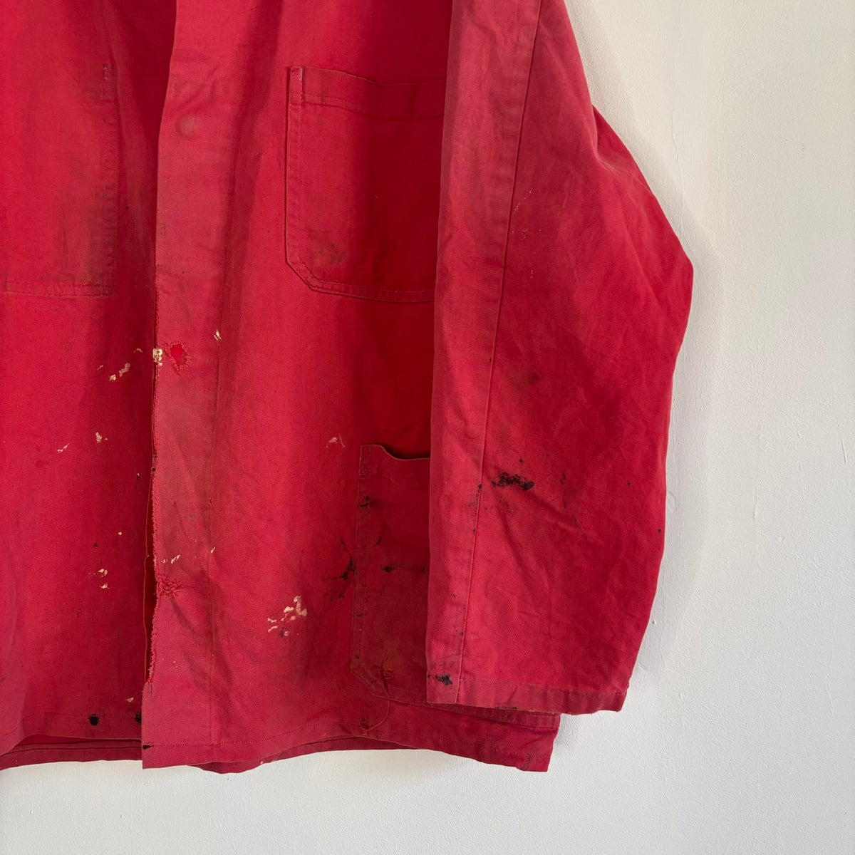 Vintage Euro workwear red chore jacket with faded paint splatters and three-pocket design.