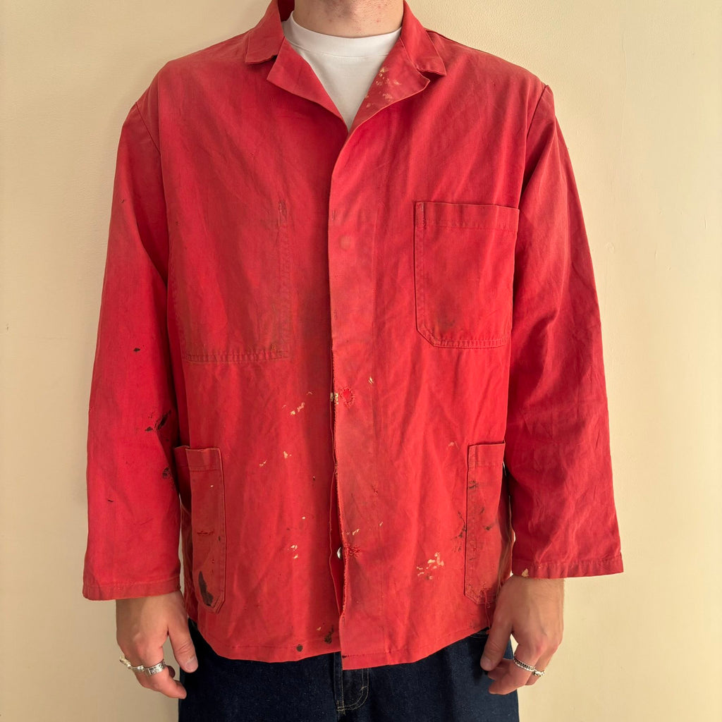 Vintage Euro workwear red chore jacket with faded paint splatters and three-pocket design.