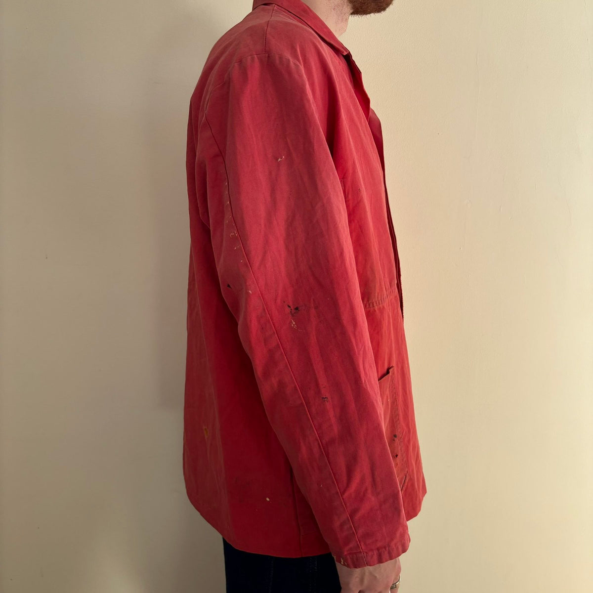 Vintage Euro workwear red chore jacket with faded paint splatters and three-pocket design.