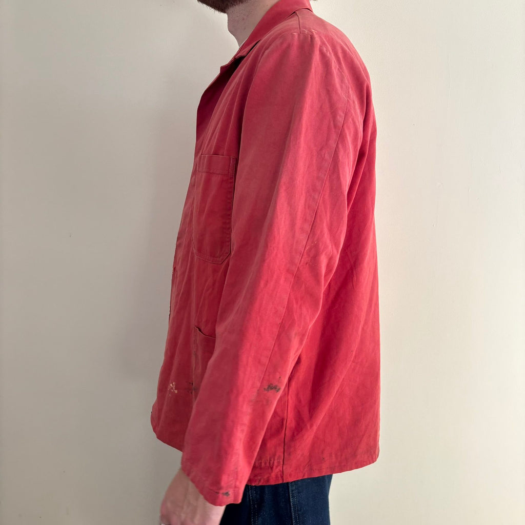 Vintage Euro workwear red chore jacket with faded paint splatters and three-pocket design.