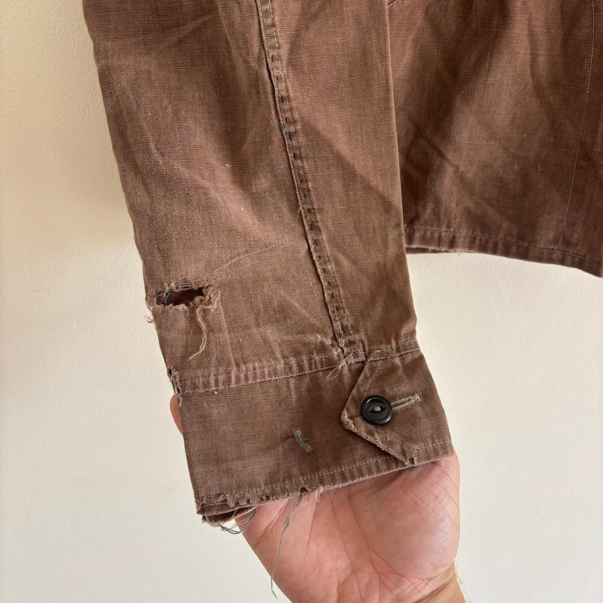 Vintage brown cropped work jacket with pointed collar and CROWN zipper pull.