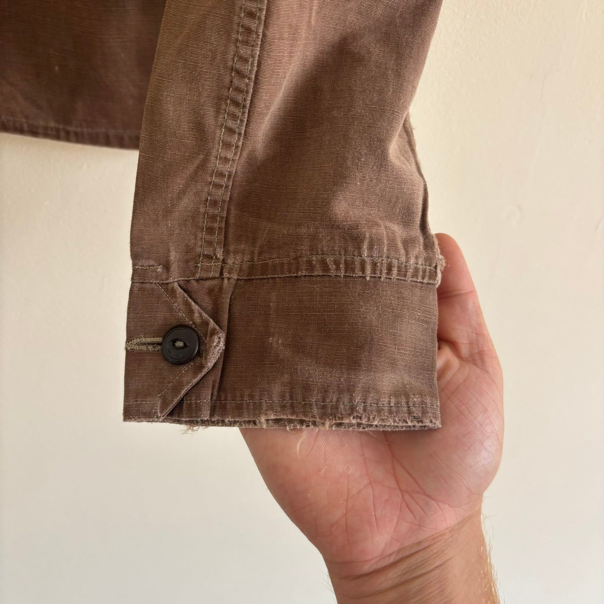 Vintage brown cropped work jacket with pointed collar and CROWN zipper pull.