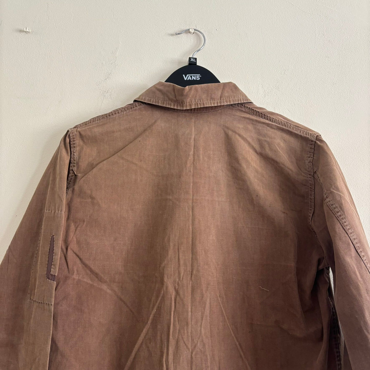 Vintage brown cropped work jacket with pointed collar and CROWN zipper pull.