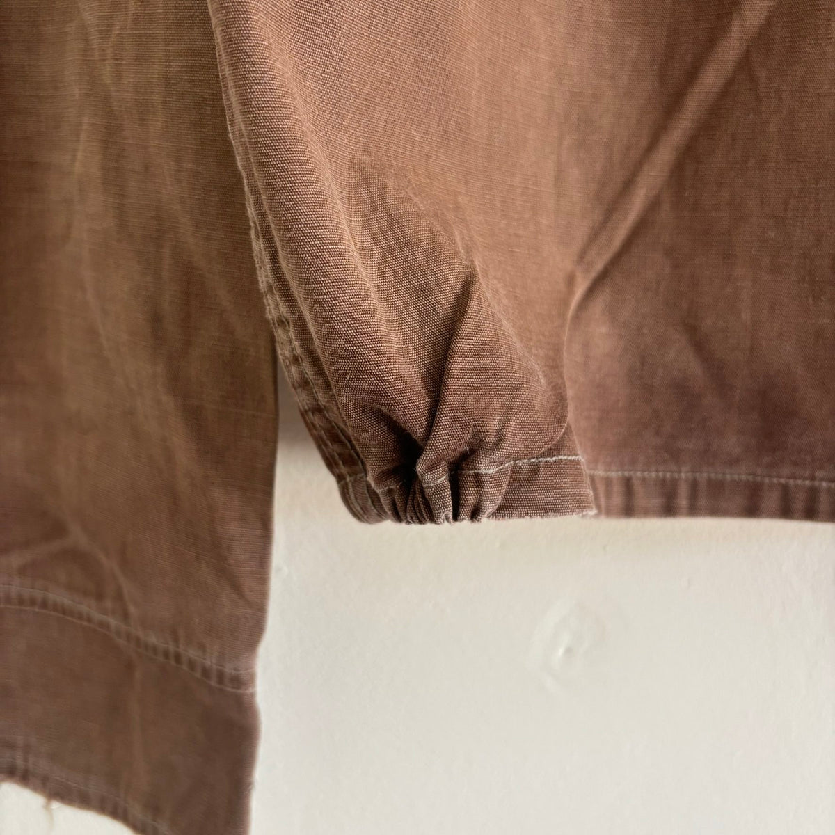 Vintage brown cropped work jacket with pointed collar and CROWN zipper pull.