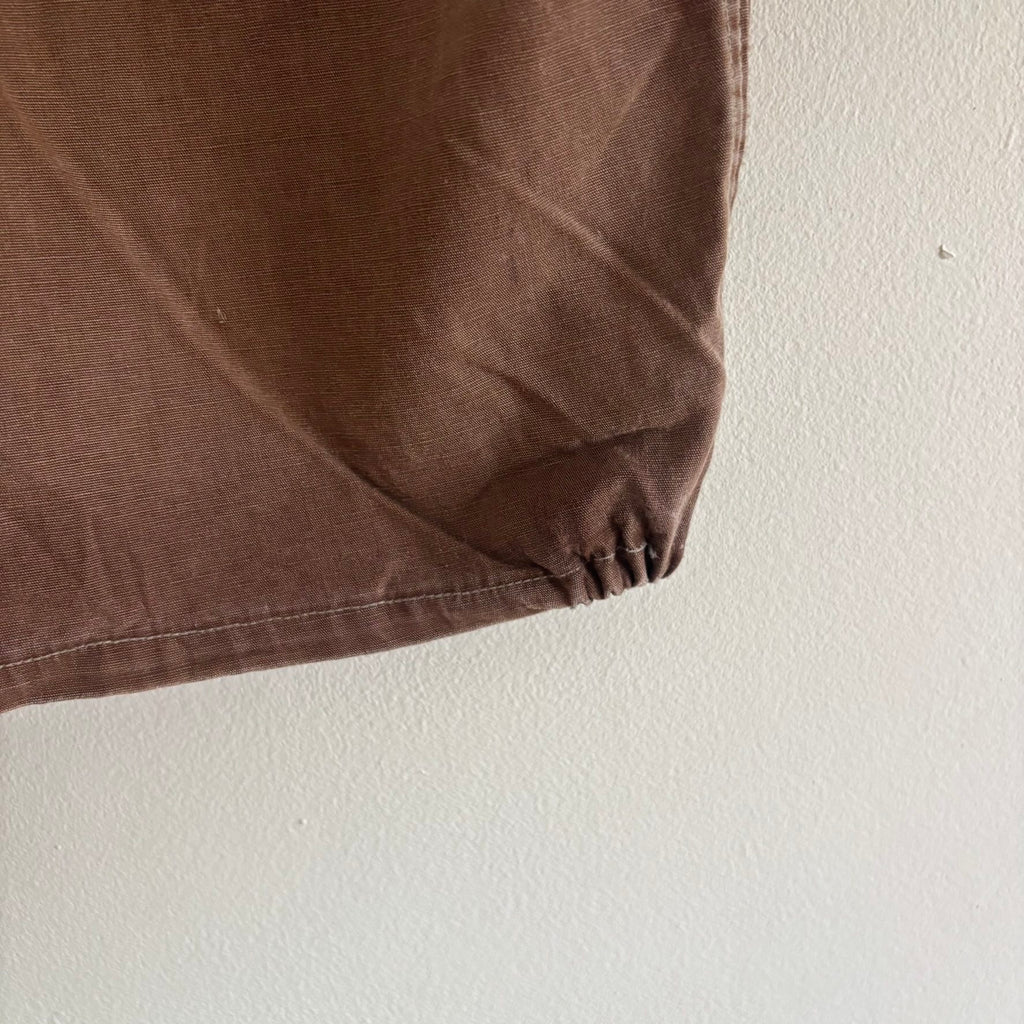 Vintage brown cropped work jacket with pointed collar and CROWN zipper pull.