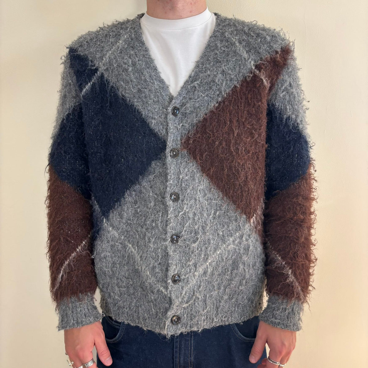 Vintage 70s knitted cardigan grey base with navy and brown oversized argyle pattern.