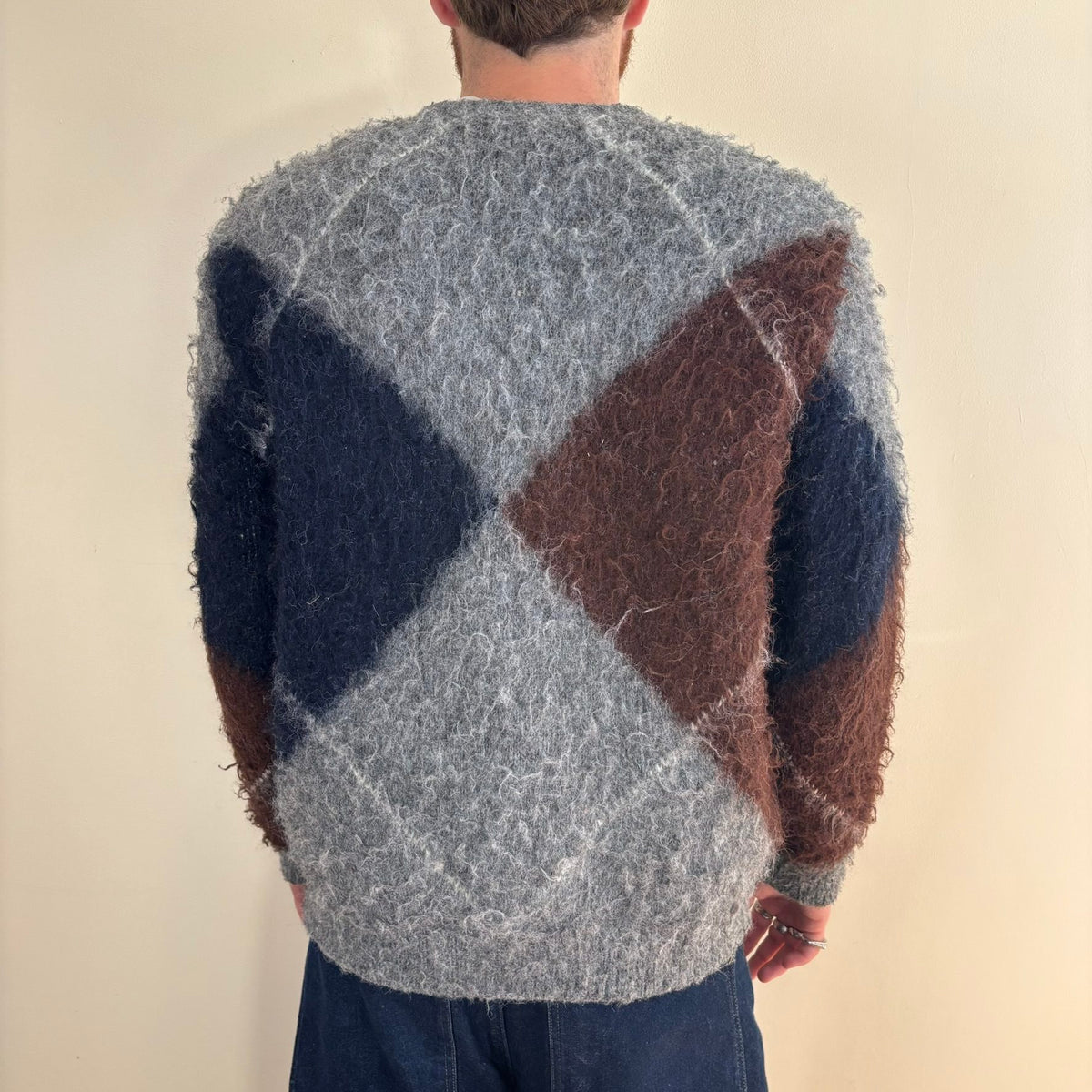 Vintage 70s knitted cardigan grey base with navy and brown oversized argyle pattern.