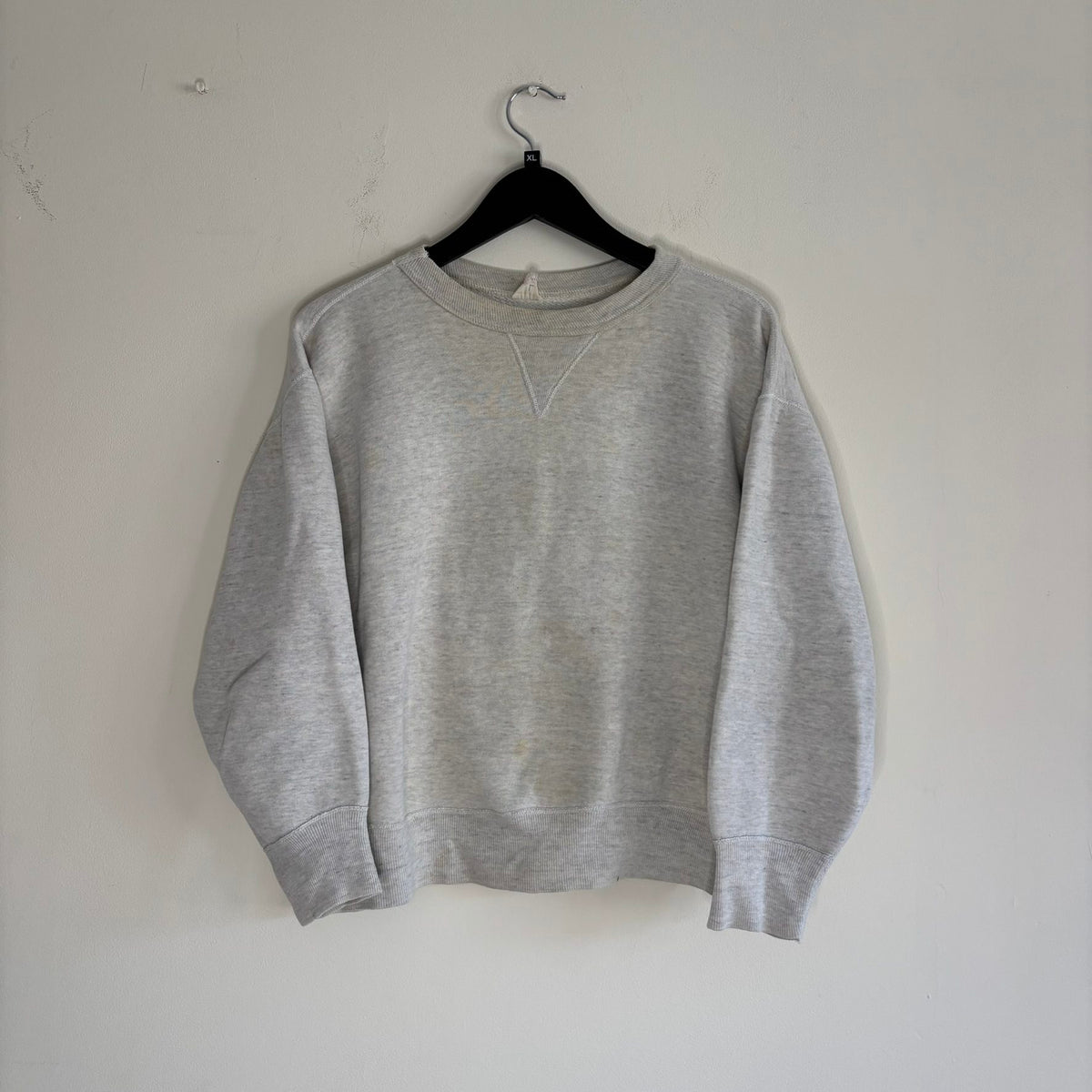 Russell Athletic grey crewneck sweatshirt with single V neck, ribbed details, and vintage tag.