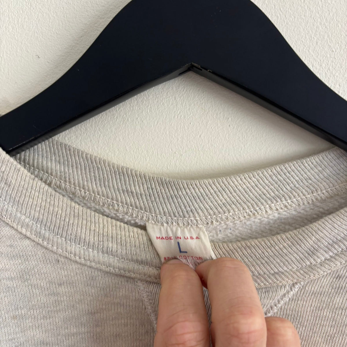 Russell Athletic grey crewneck sweatshirt with single V neck, ribbed details, and vintage tag.