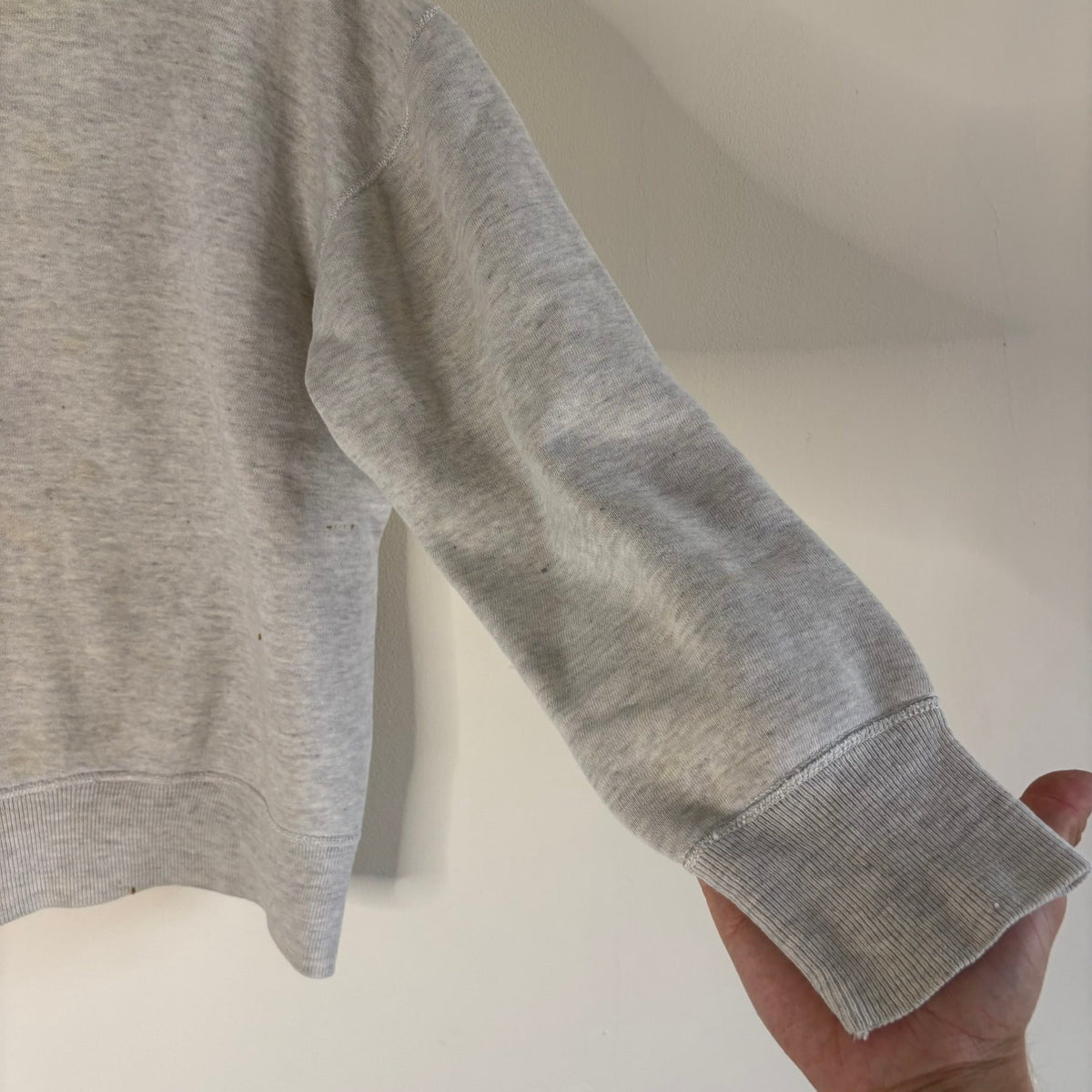 Russell Athletic grey crewneck sweatshirt with single V neck, ribbed details, and vintage tag.