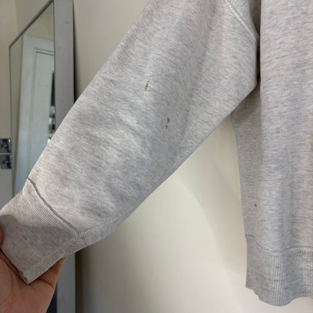 Russell Athletic grey crewneck sweatshirt with single V neck, ribbed details, and vintage tag.