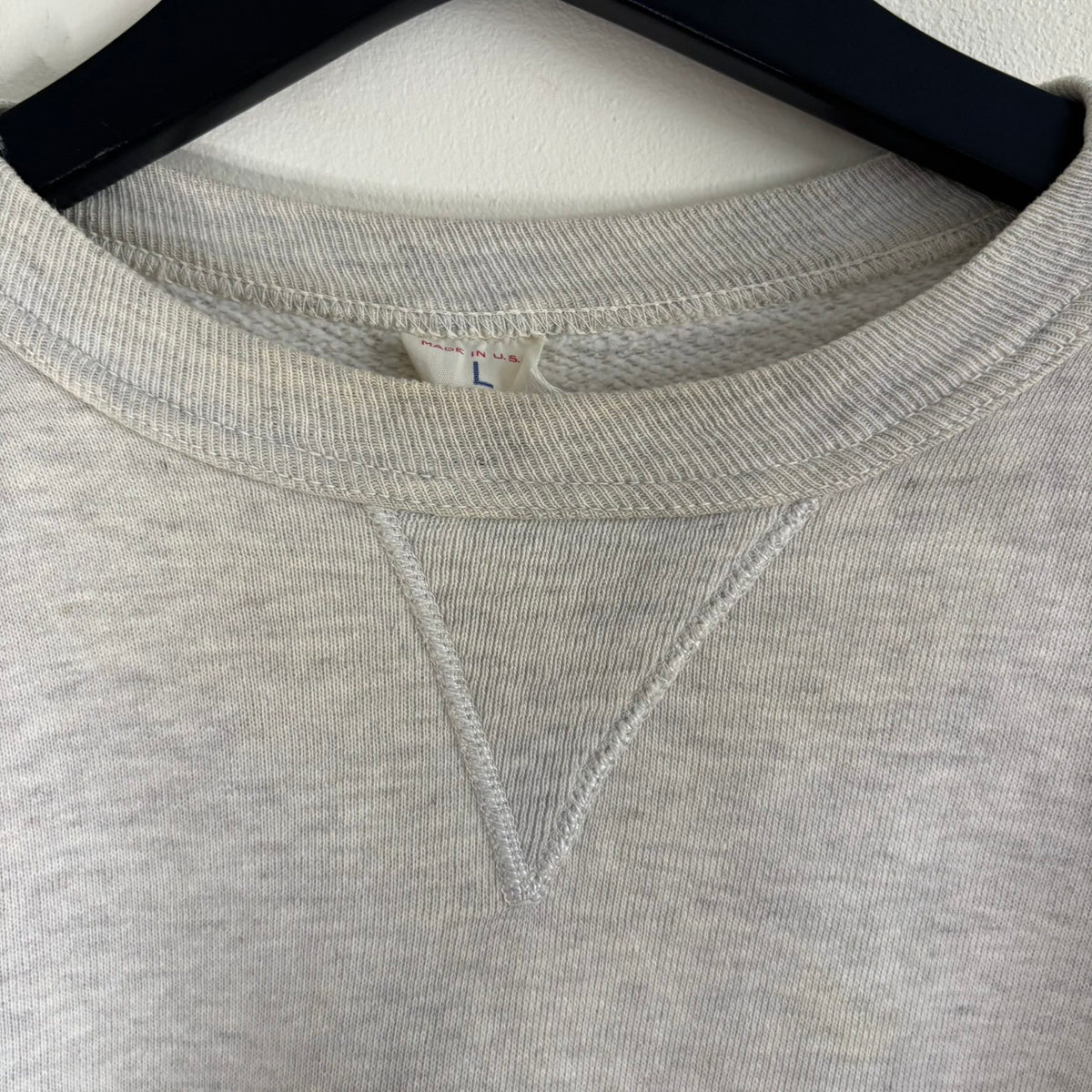 Russell Athletic grey crewneck sweatshirt with single V neck, ribbed details, and vintage tag.