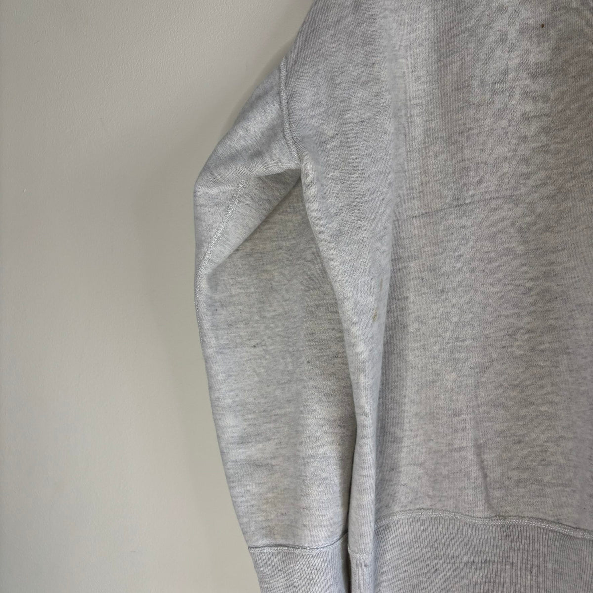 Russell Athletic grey crewneck sweatshirt with single V neck, ribbed details, and vintage tag.