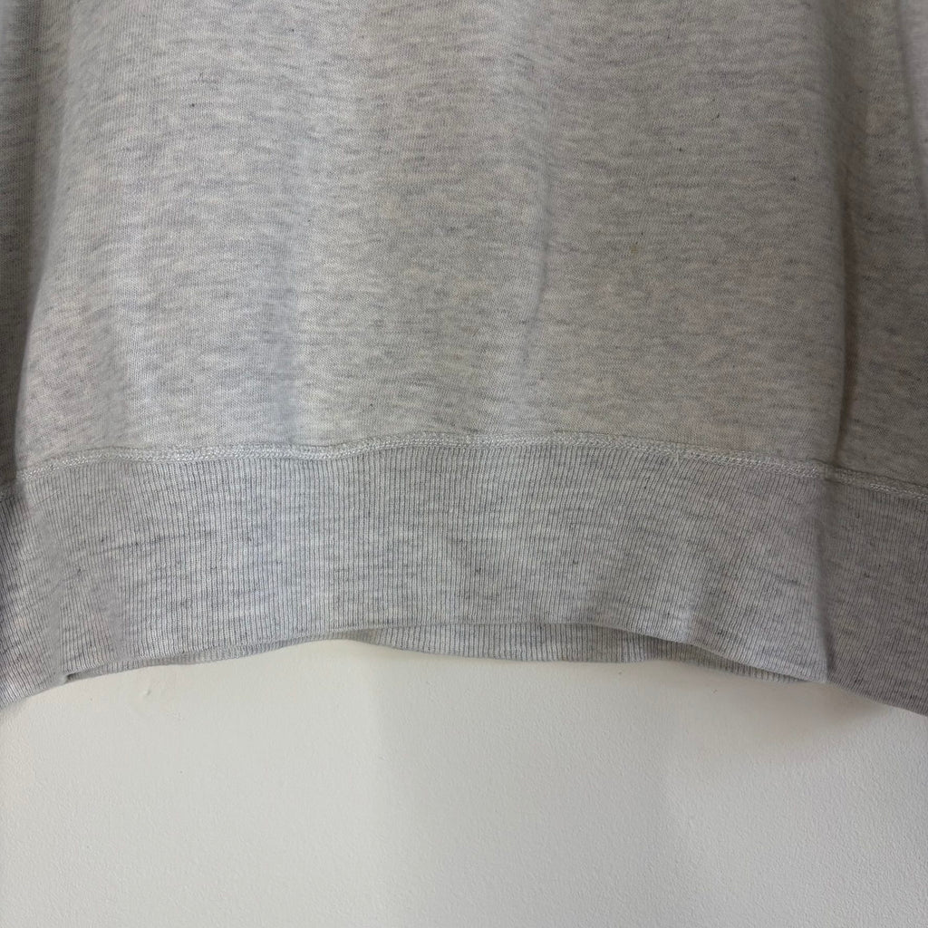 Russell Athletic grey crewneck sweatshirt with single V neck, ribbed details, and vintage tag.